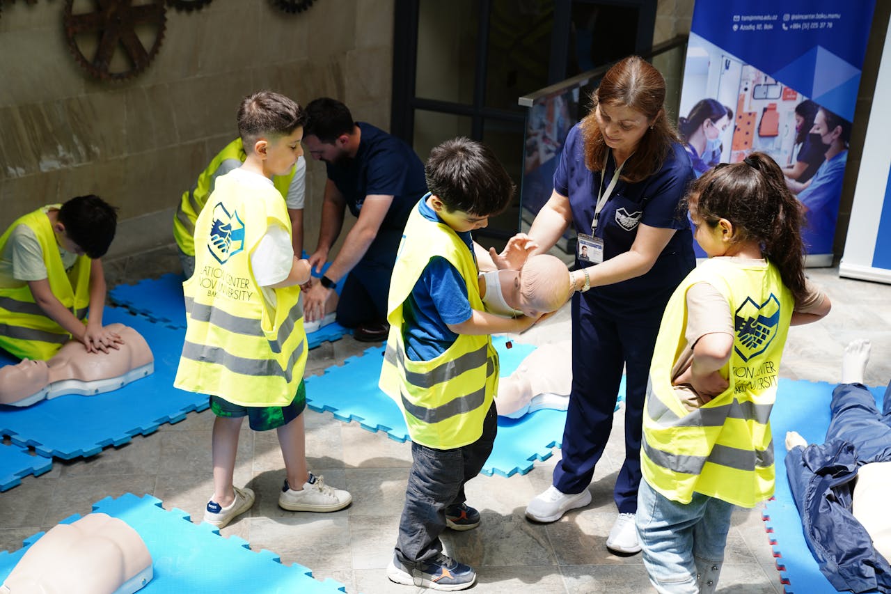 The Art of Drawing Readers In: Your attractive post title goes here Kids learning CPR skills in an educational safety workshop indoors led by instructor.